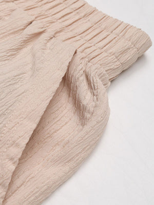 Textured tan cargo trousers with drawstring waist and pocket detail.