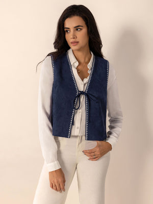 Dark blue suede-effect vest with white stitch trim and tie front closure.