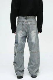 Medium wash wide leg cargo jeans with utility pockets and a relaxed fit.
