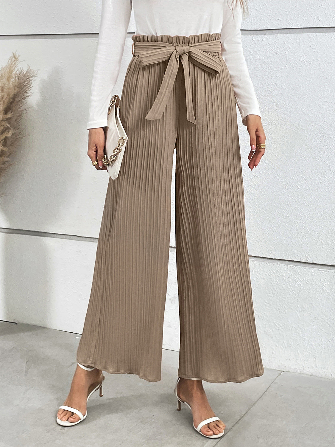 Camel pleated palazzo trousers with tie waist and wide legs.