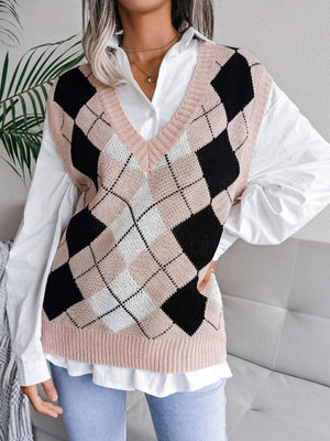 Argyle knit sweater vest in dusty pink, black, and white with a V-neck, layered over a white shirt.