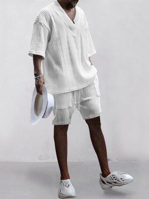 White cable-knit v-neck two-piece set with shorts and short sleeves.