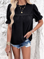 Black eyelet blouse with ruffled puff sleeves and a mock neck