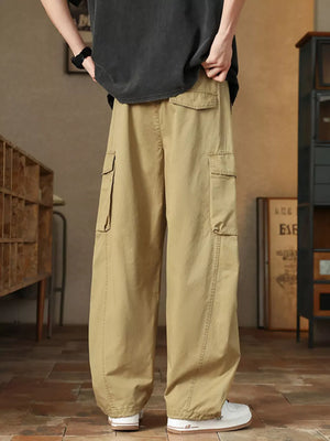Khaki cargo pants with drawstring waist and multiple pockets, styled casually.