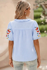 Blue striped cotton shirt with embroidered floral puff sleeves and frill collar.