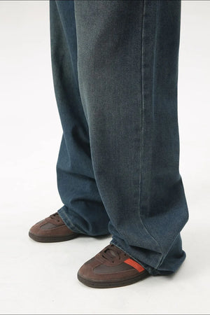 Baggy denim jeans in medium wash with subtle fading and a relaxed fit.