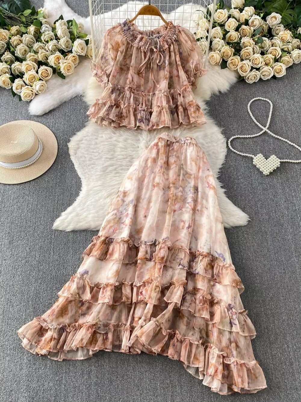 Floral ruffle set with bow detail in pink and brown tones.