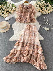 Floral ruffle set with bow detail in pink and brown tones.