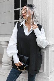 Black oversized knit vest with V-neck and pockets, styled with a white shirt.