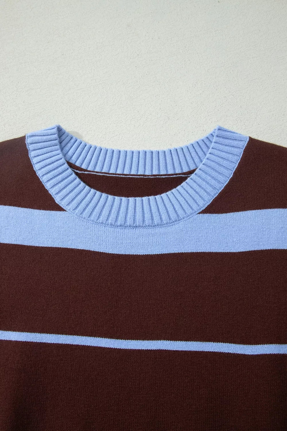 Chic striped knit sweater with crew neck and ribbed details in brown and light blue.