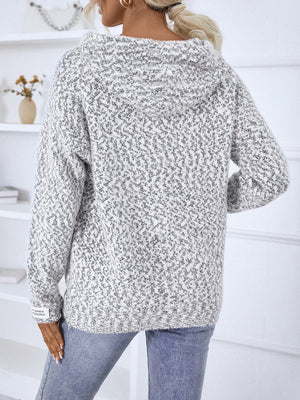 Textured knit zip-up cardigan in white with a subtle charcoal fleck pattern and a cozy hood.