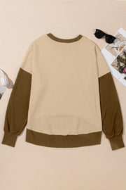 Crewneck sweatshirt in tan with contrasting brown sleeves and hem.