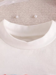 Toddler white cotton t-shirt with patriotic graphic detail and pearl embellishments.