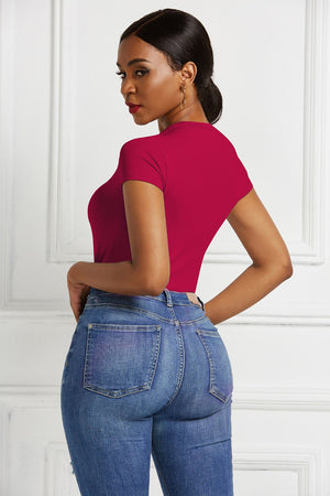 Sculpted crew neck bodysuit in Scarlet with short sleeves, paired with blue denim jeans.