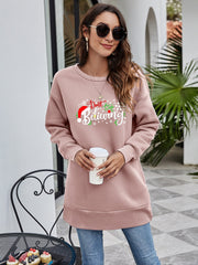 Dusty Pink graphic tunic sweatshirt with "Don't stop believing" holiday print and Santa hat detail.