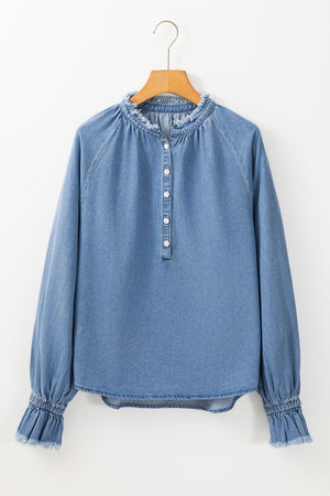 Light blue denim blouse with ruffled collar, button front, and ruffled cuffs.