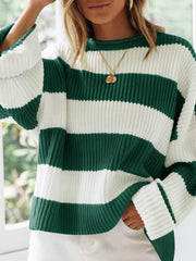 Striped oversized knit sweater in dark green and white with a crew neck and long sleeves.