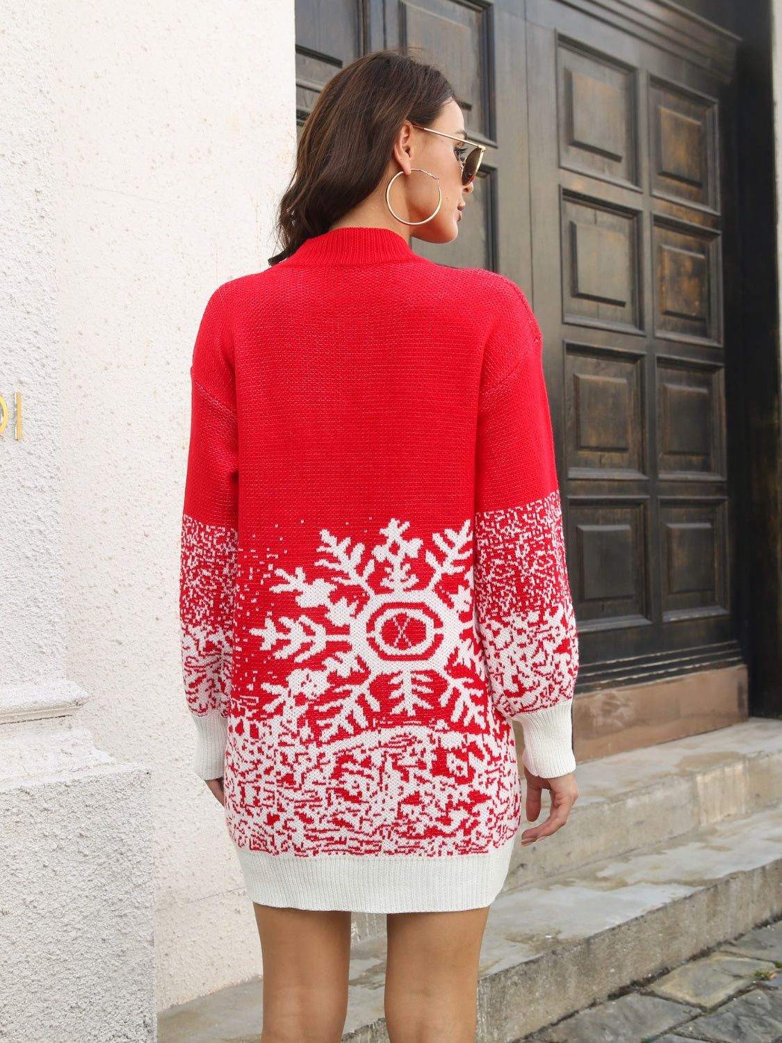 Red knit mini dress with white snowflake intarsia pattern and white cuffs.