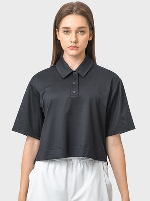 Black cropped polo sportif top with short sleeves and button placket.