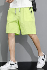 Men's lime green quick-dry drawstring shorts with zip pockets