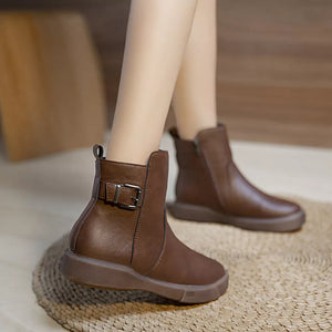 Brown round toe platform ankle boots with decorative buckle detail