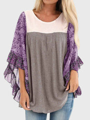 Textured panel blouse in gray with purple floral flutter sleeves and ruffled trim.