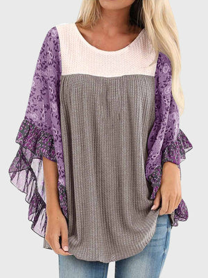 Textured panel blouse in gray with purple floral flutter sleeves and ruffled trim.