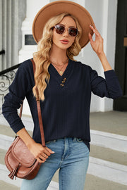 Dark blue cable-knit henley pullover with textured fabric and button detail