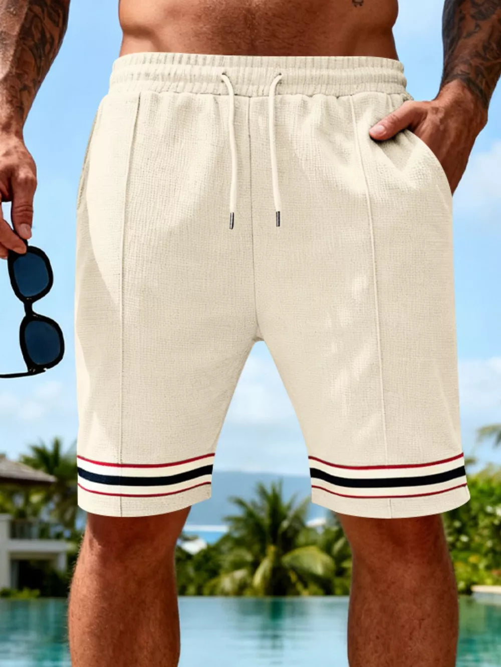 Textured knit drawstring shorts in apricot with striped cuffs and pockets.