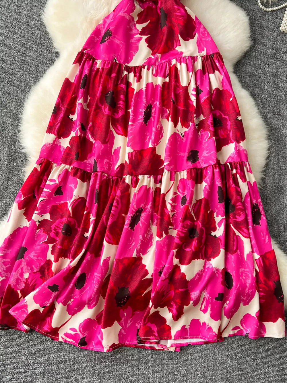 Vibrant floral tiered cami maternity swim dress with pink and red flowers on a cream background.