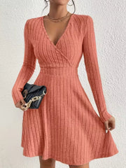 Burnt Coral ribbed wrap mini dress with V-neck and long sleeves.