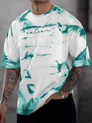 Abstract tie-dye oversized men's t-shirt in turquoise and white cotton with crew neck.