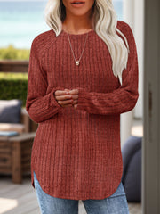 Burgundy ribbed knit sweater with raglan sleeves and asymmetric hem.