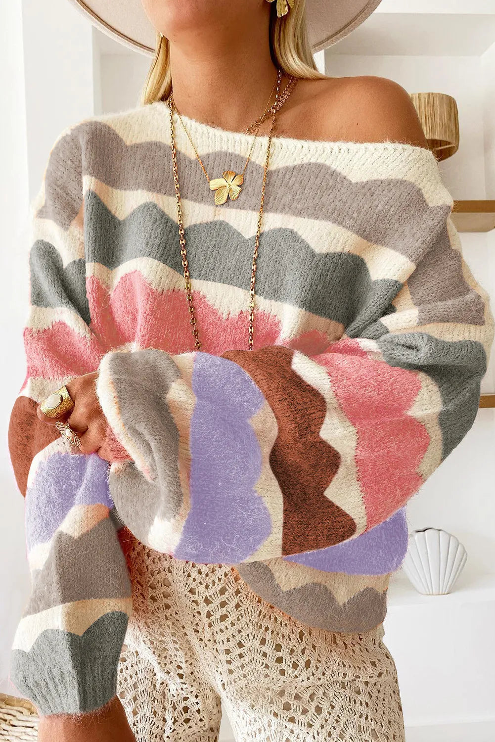 Scalloped stripe off-the-shoulder knit sweater with boat neckline and acrylic material.