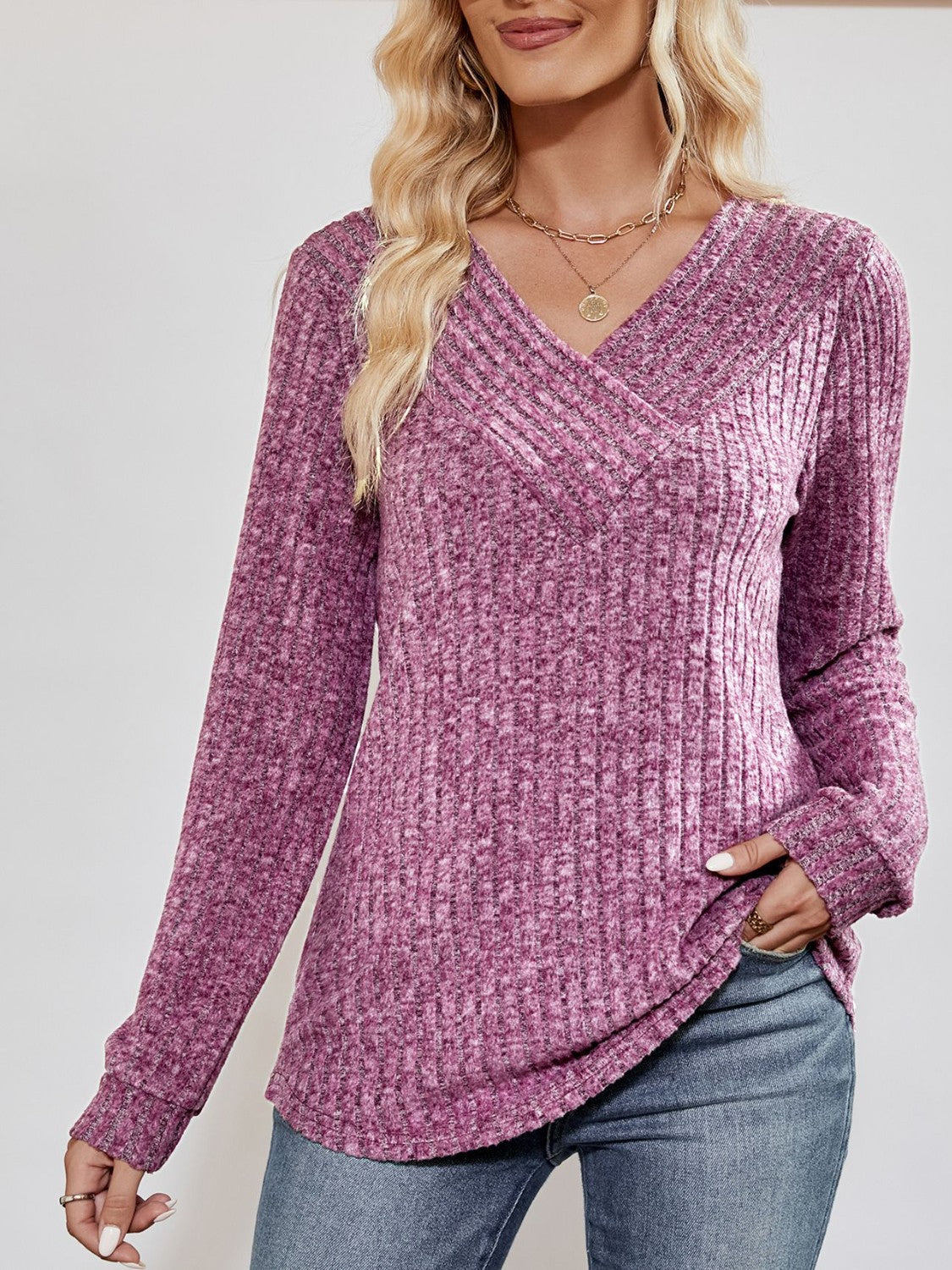 Lilac textured ribbed V-neck pullover sweater with long sleeves.
