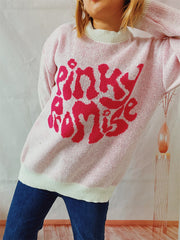 Blush pink knit jumper with a cream neckline and bold pink "Pinky Promise" graphic.