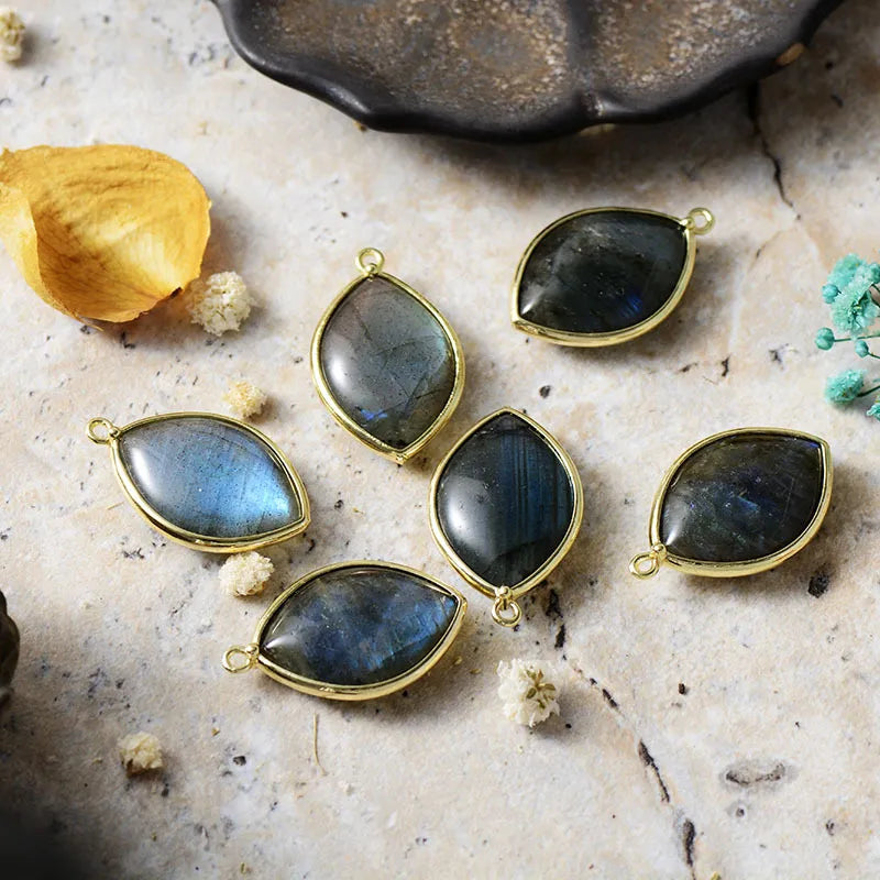 Cosmic Quartz Droplet Earrings in black and light green with gold trim.