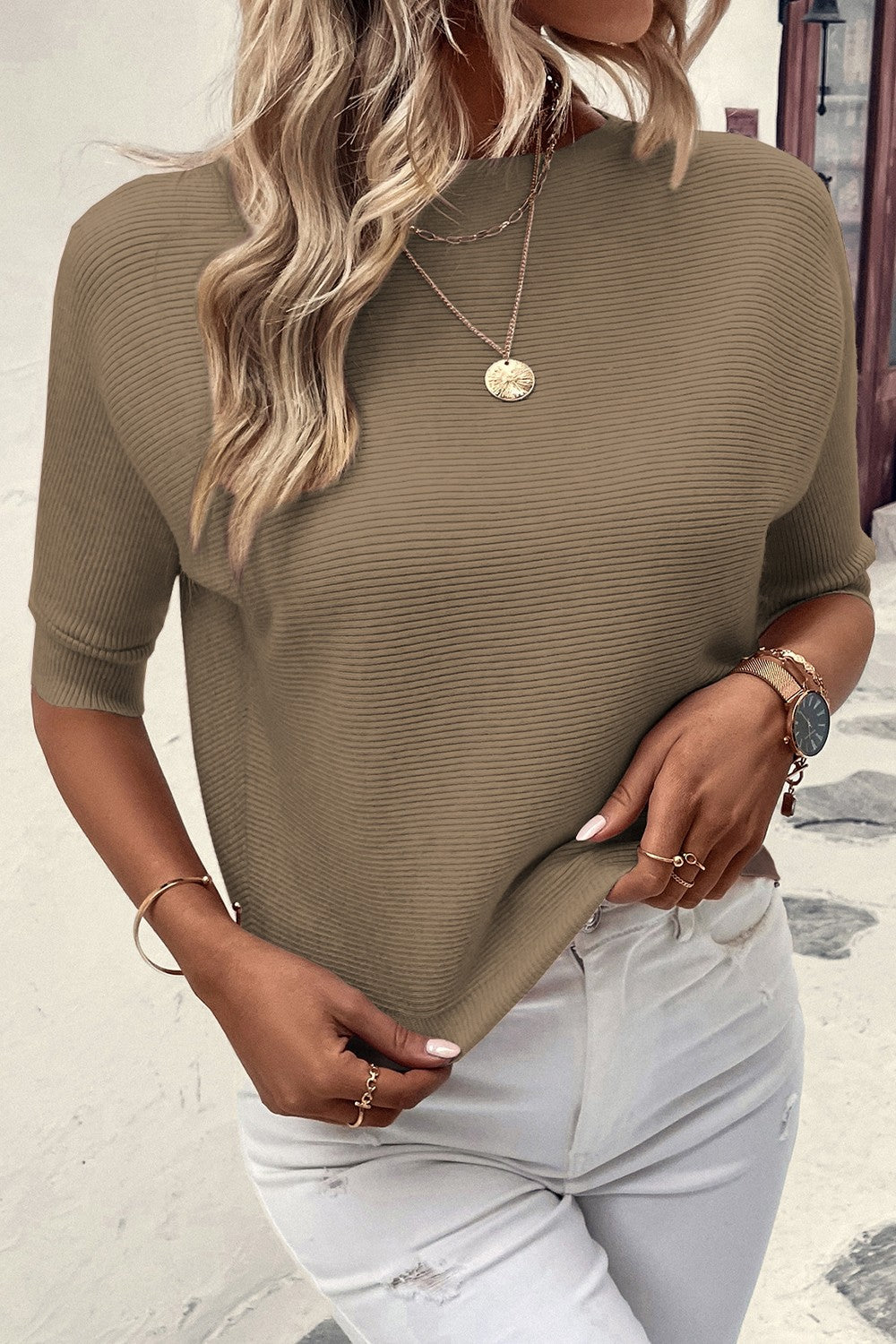 Off-the-shoulder ribbed knit top in olive with short dolman sleeves.