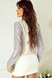 Ivory silk blend blouse with full sequin sleeves.