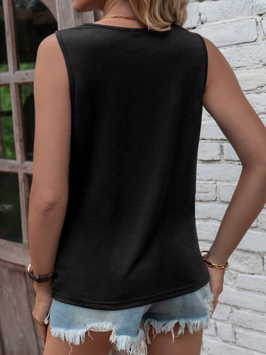 Black tank top with slit detail and knot accent, casual sleeveless top
