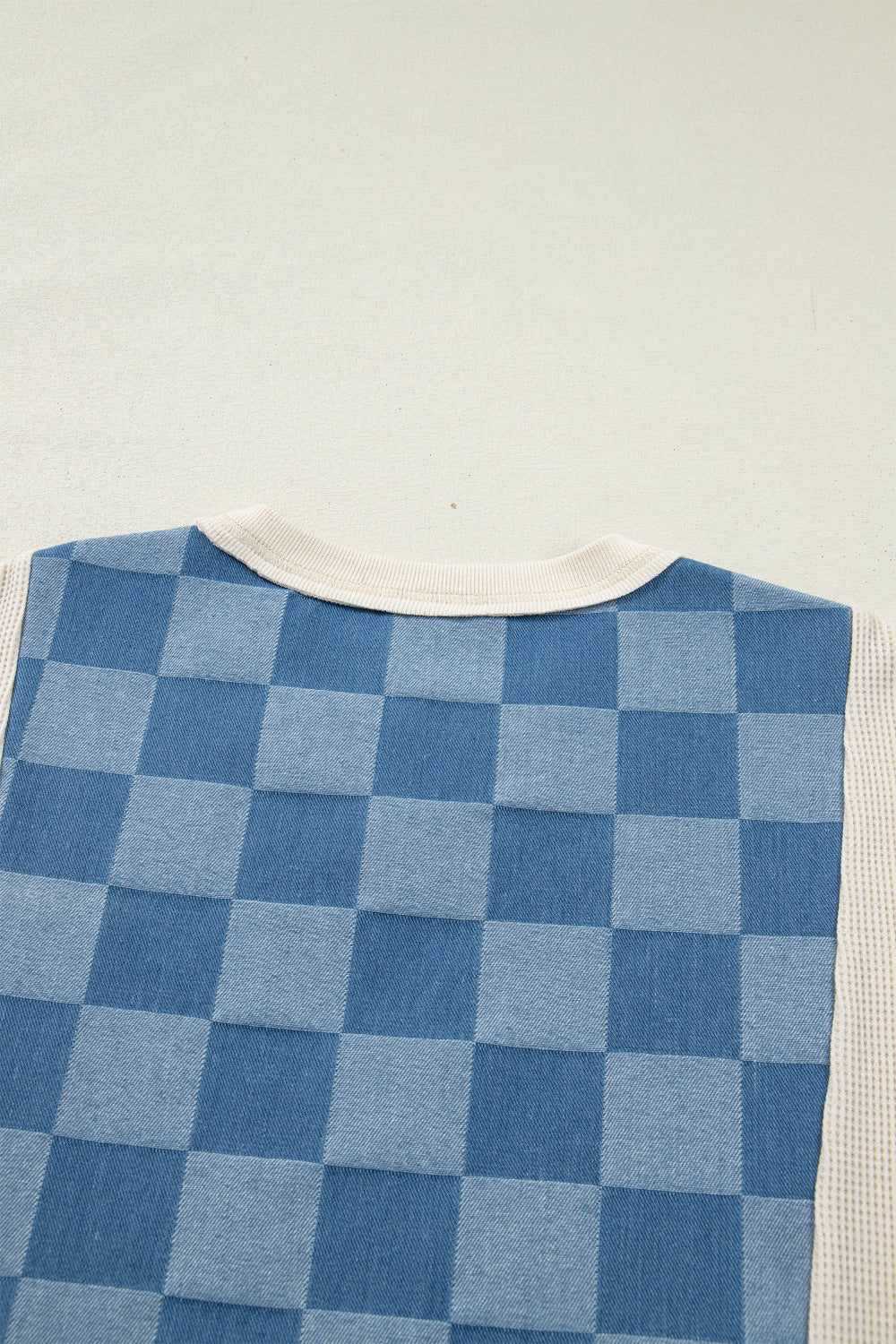Maternity T-shirt with blue checkered denim front and cream waffle knit sleeves.