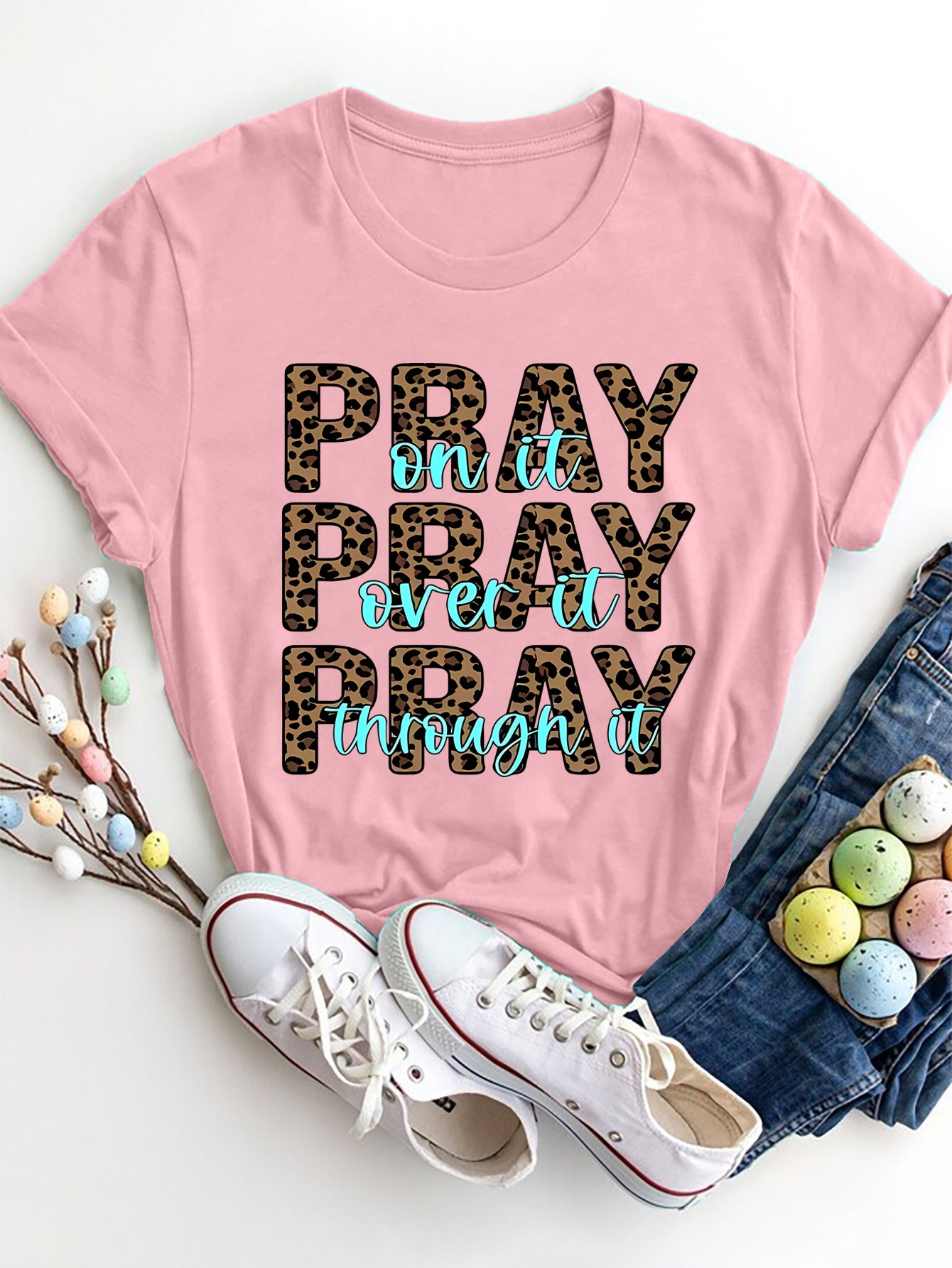 Blush pink graphic tee with leopard print and turquoise text saying Pray on it, Pray over it, Pray through it.