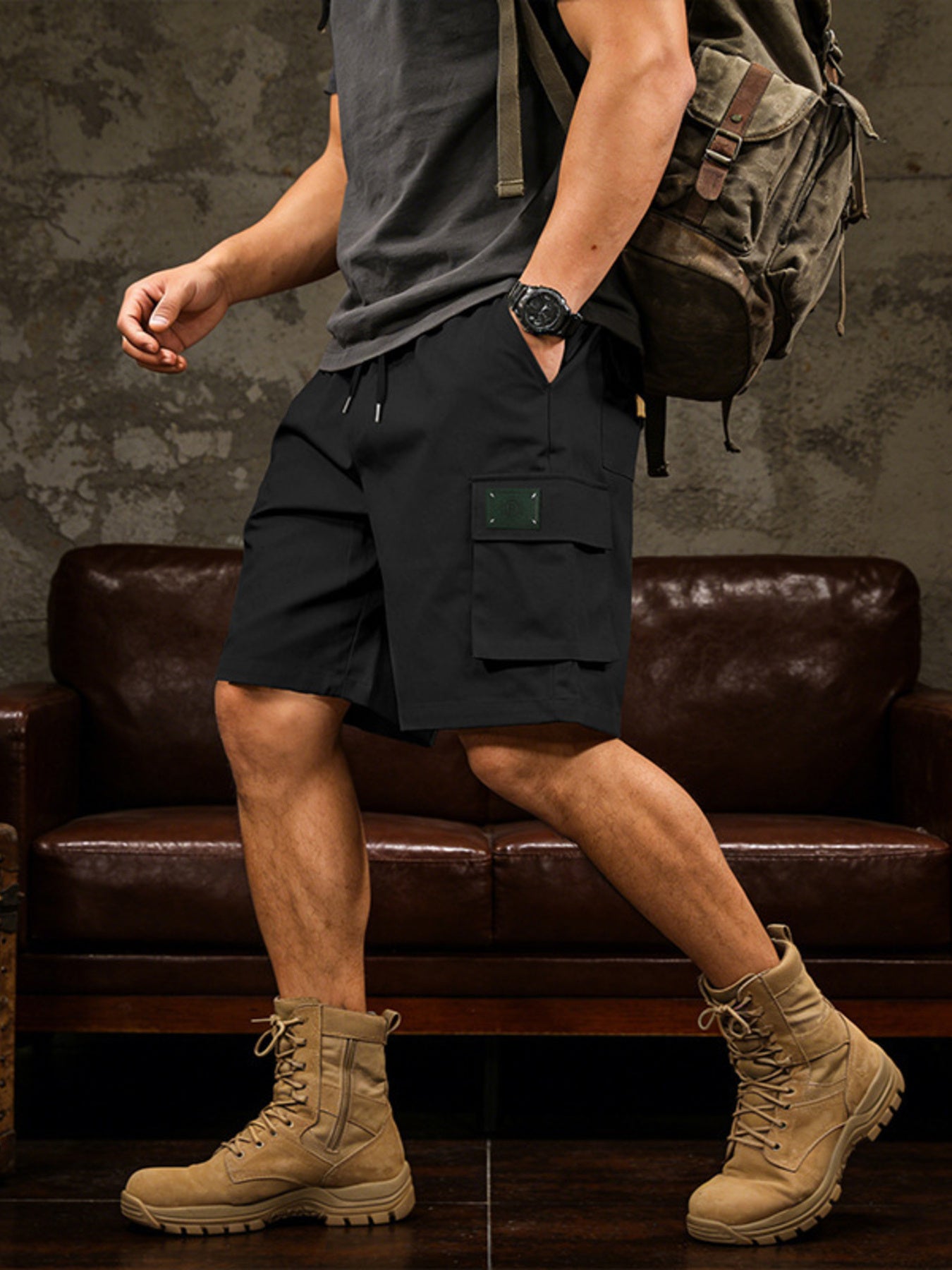 Black cargo shorts with drawstring waist and utility pocket detail