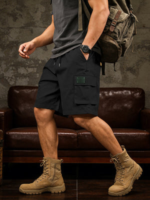 Black cargo shorts with drawstring waist and utility pocket detail