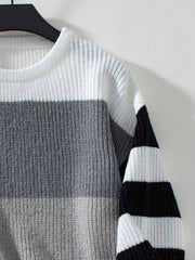 Colorblock stripe ribbed knit sweater with white, gray, and black horizontal stripes.