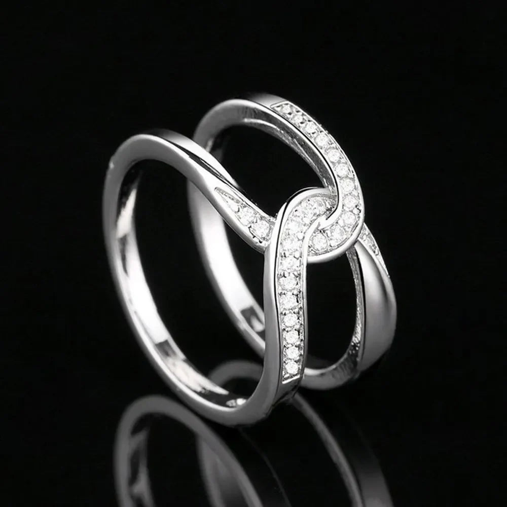 Silver pavé band ring with intertwined design