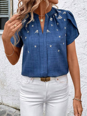 Blue embroidered floral keyhole blouse with short flutter sleeves.