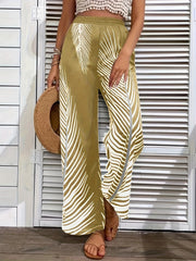 Khaki palazzo trousers with white palm print and a side slit, styled with a crochet top and sandals.