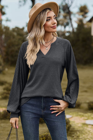 Dark gray waffle knit raglan top with laser cut sleeves and v-neck