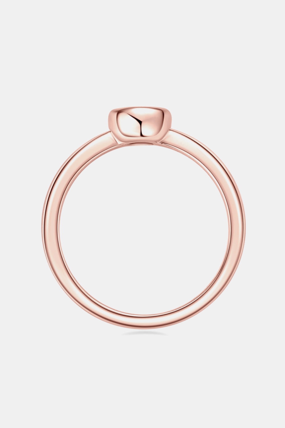 Rose gold solitaire bezel ring with a thin band.